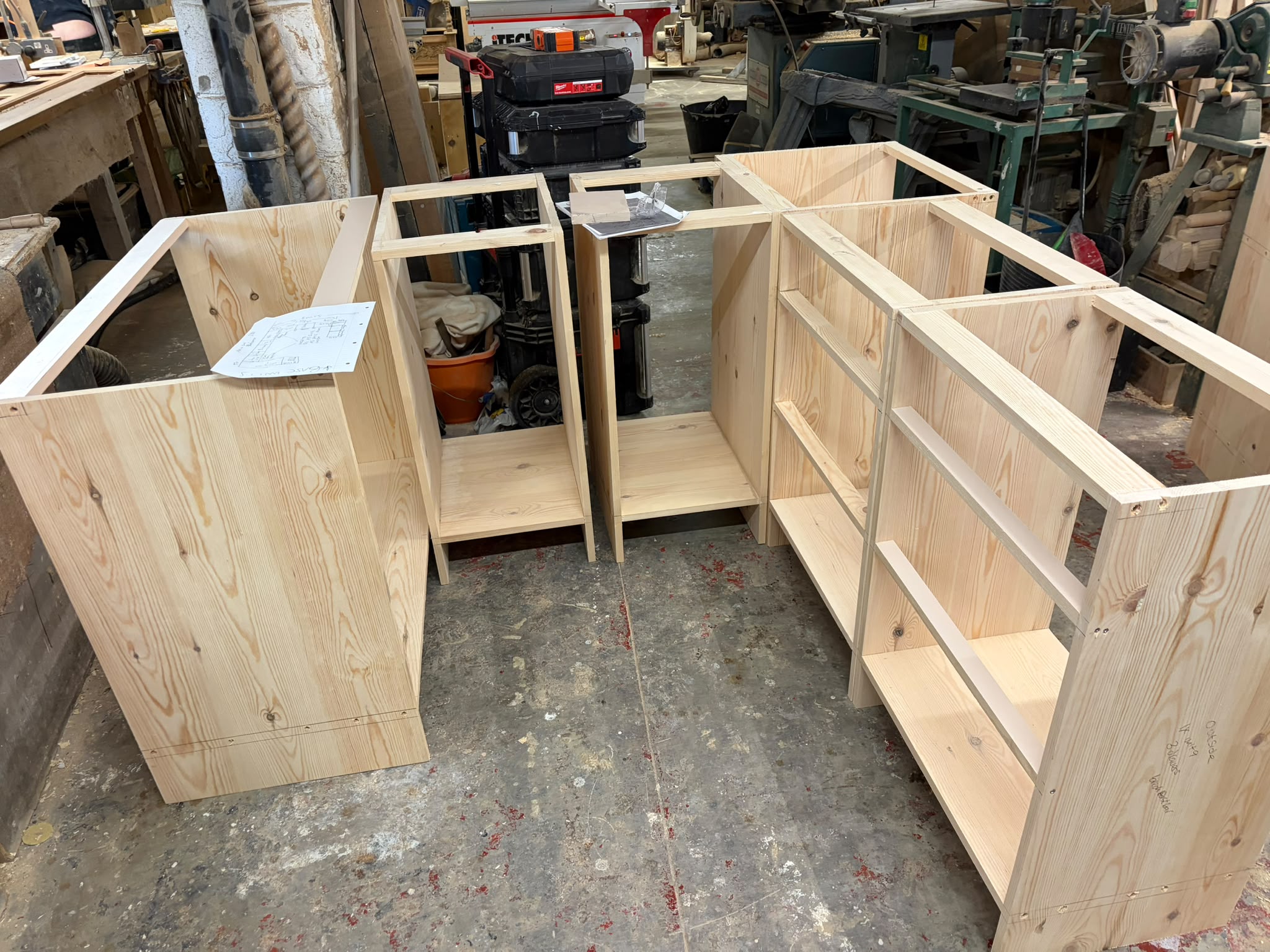 Bespoke pine bookcase carcasses in three sections being built in the Oak & Pine by Design workshop, Honley, Yorkshire