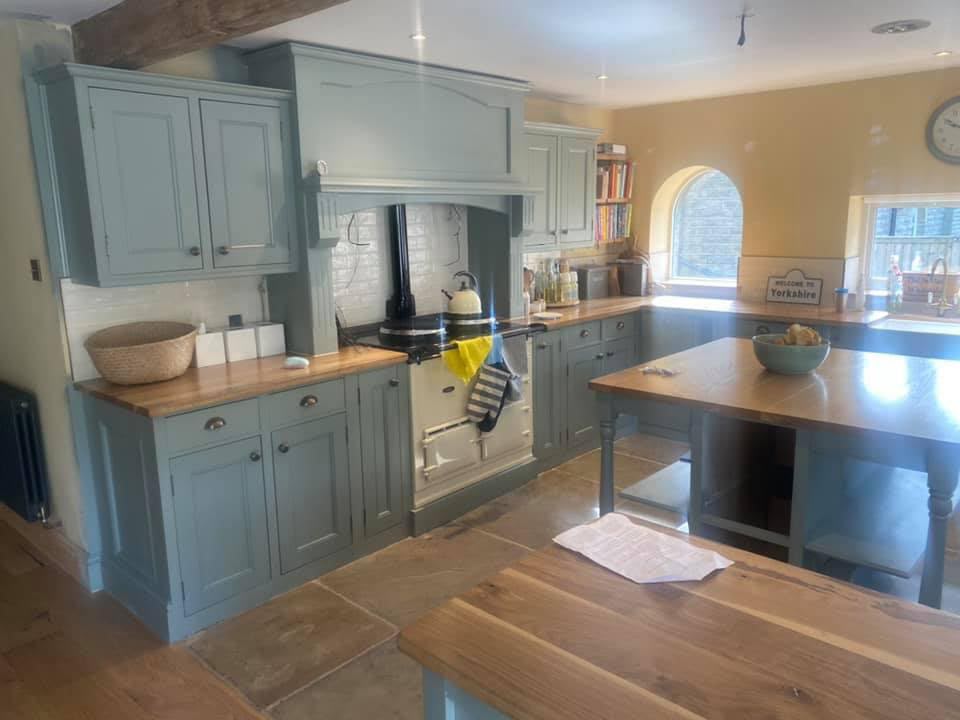 Hand-painted sage teal country kitchen with a cream Aga, solid wood worktops, central island and exposed beam — Oak & Pine by Design, Yorkshire