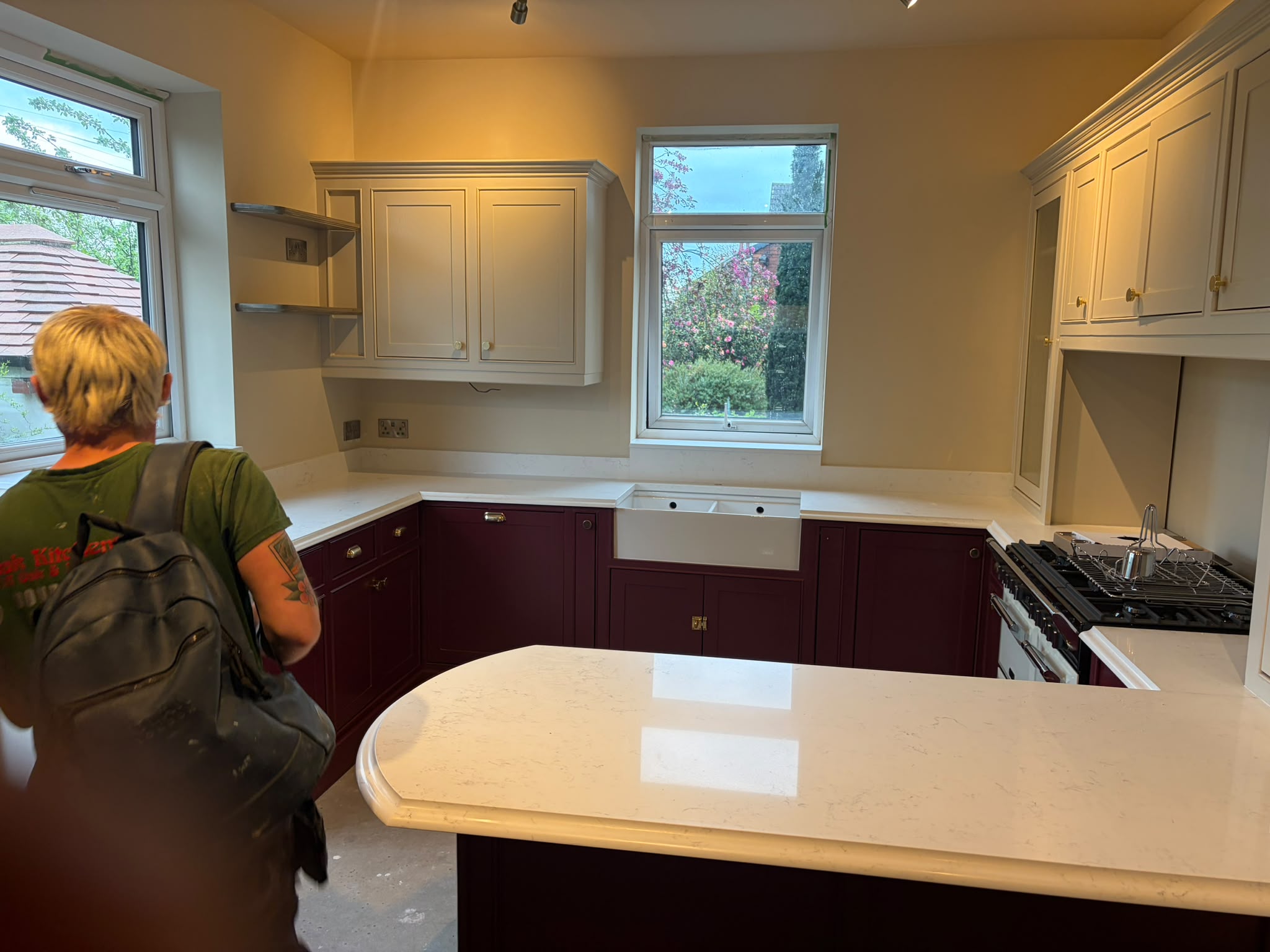 Two-tone handmade Shaker kitchen painted claret and cream with brass cup pulls, range cooker and butler sink — Oak & Pine by Design, Yorkshire